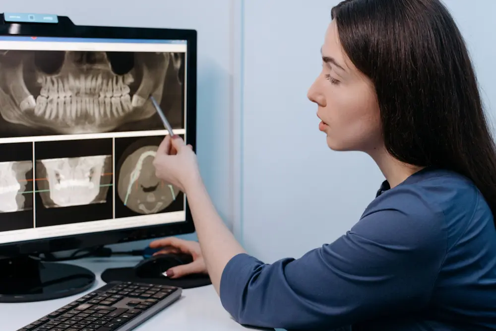 pexels-cottonbro-studio-6502026-2048x1366 | London Dental Institute dentist assessing a cbct scan